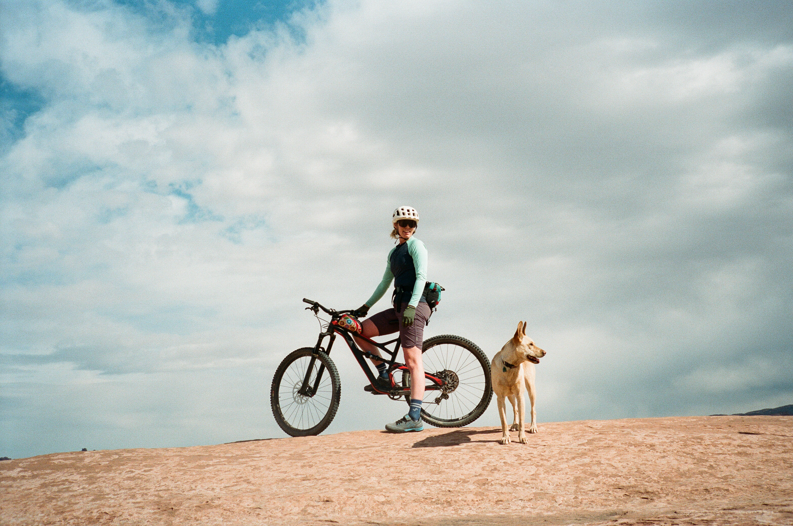 A rider and a dog on slickrock
